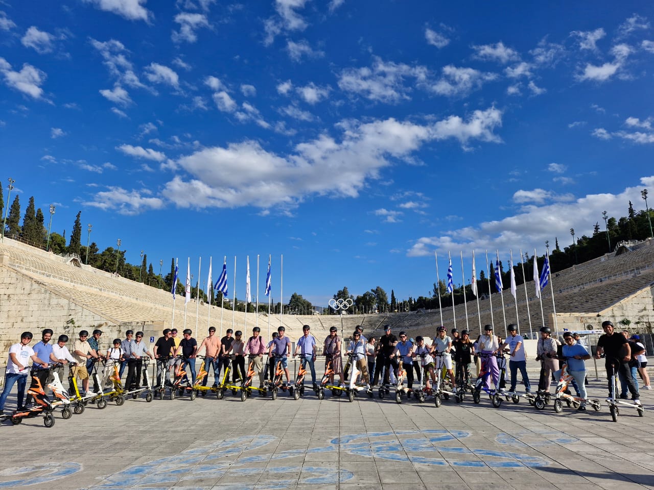 Panathenaic Stadium with a team of trikke scooters. An Athens tour by Scooterise guides in a sunny weather, suitable for families with kids.